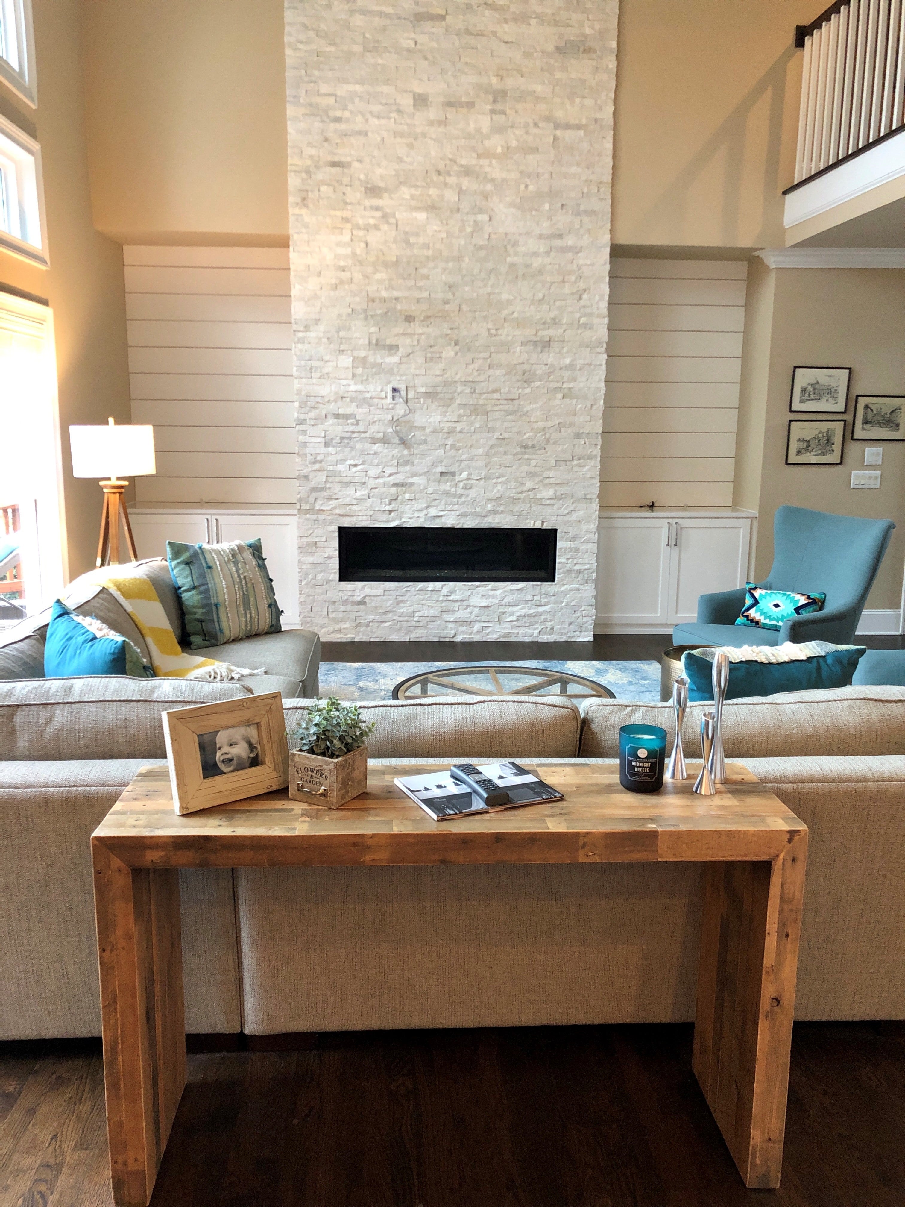 Norstone White Rock Panels used on a two story residential fireplace with a well designed living room with neutral color pallete with light blue accents